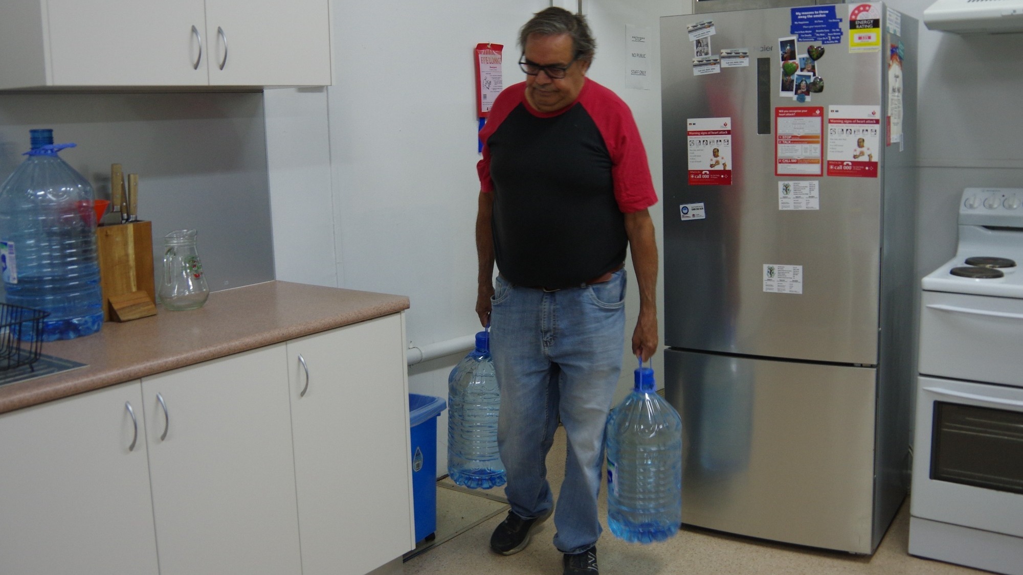 DEG's Bow Simpson lugging drinking water every morning for DEG's Elders Centre