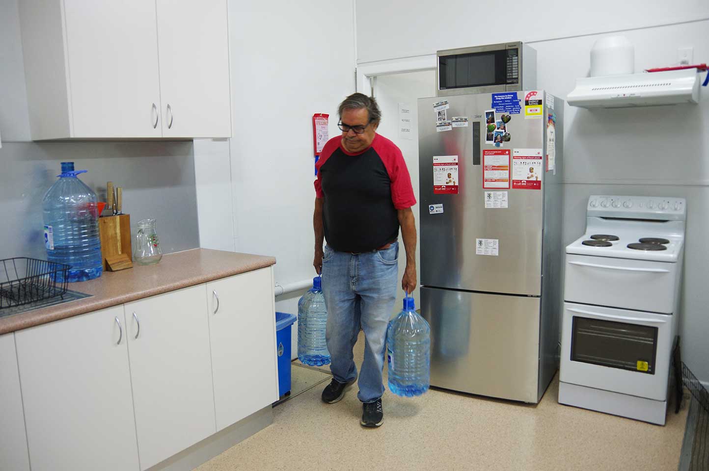 Bow Simpson lugging bought water for DEG Elders Centre